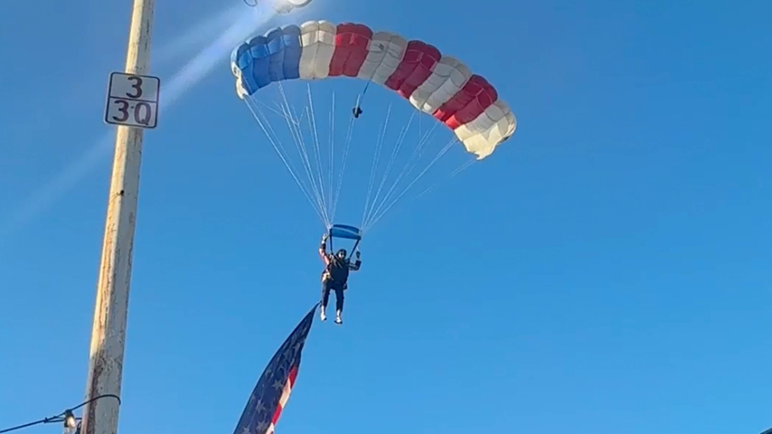 Watch: Star-spangled skydiver crash-lands into packed rodeo